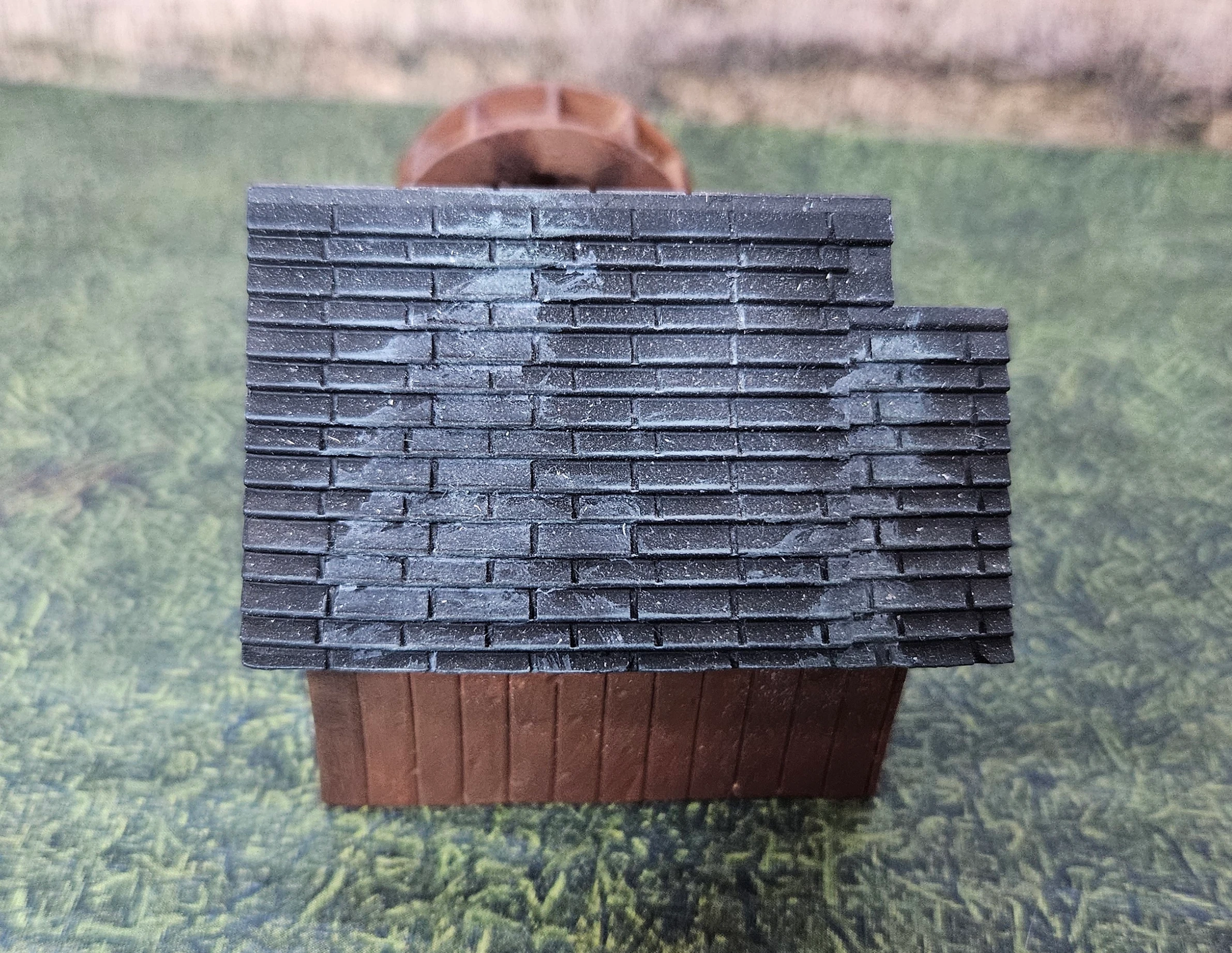 Rear angled view of HO scale waterwheel with small building